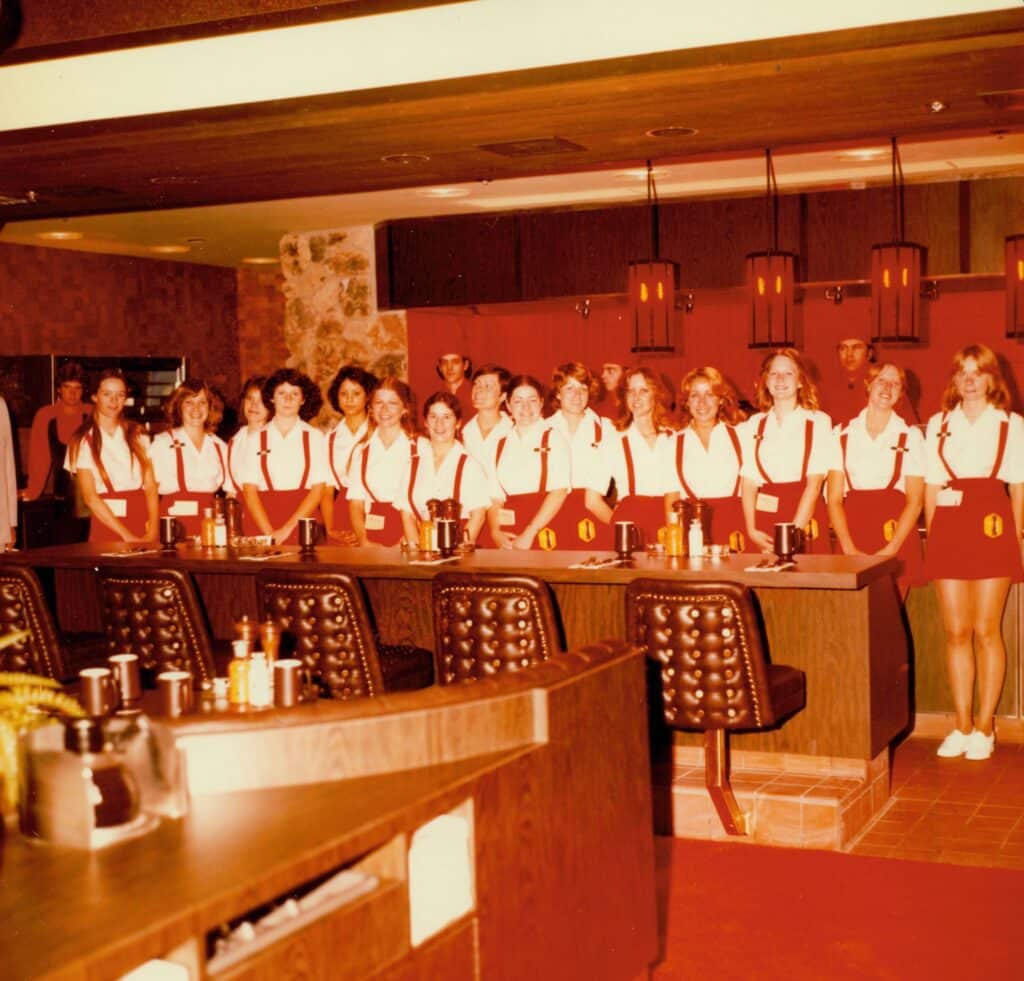A lineup of waitresses in cheerleading outfits, 1984, at The Peppermill restaurant.